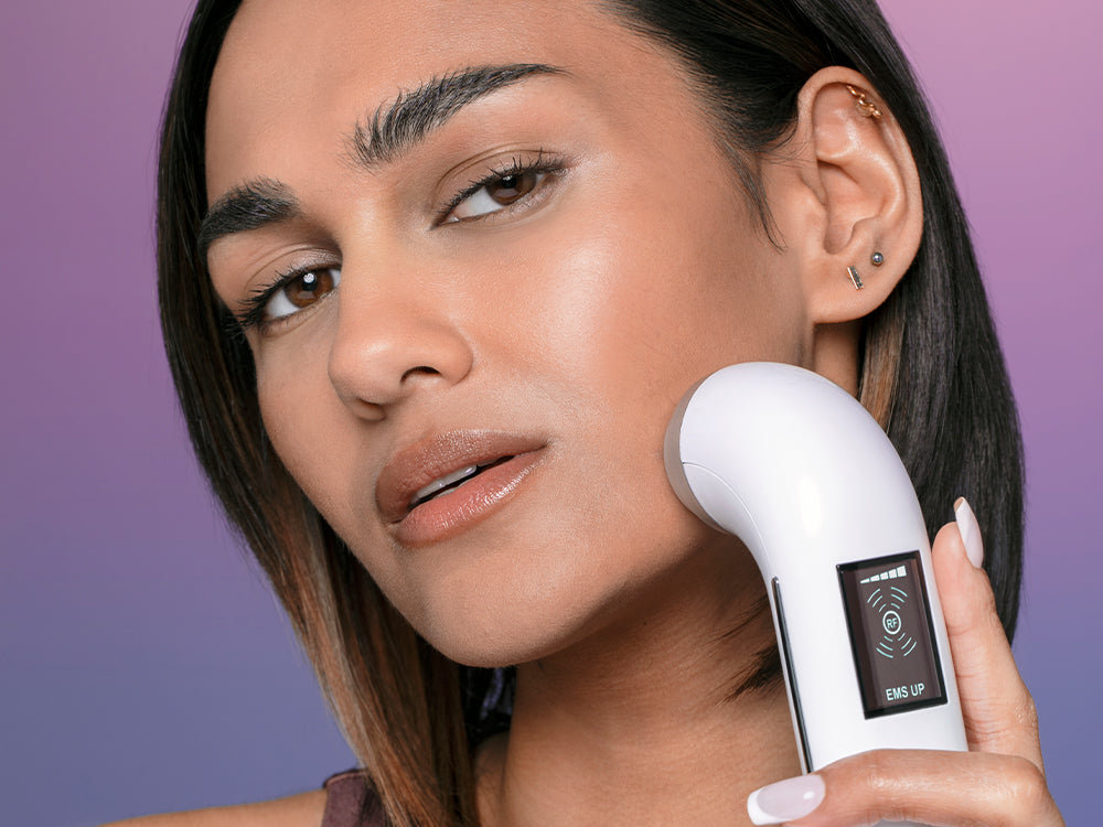 Model using the electrical muscle stimulation setting on the Rejuvenate Beauty Device.