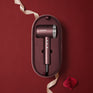 The Dark Burgundy Airshot Pro hair dryer in a matching case on a red background with 'Cloud Nine' branding.