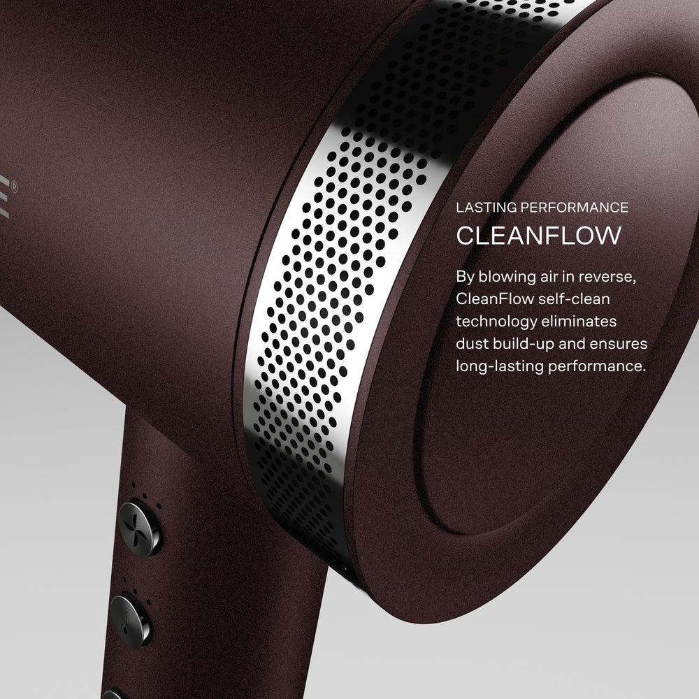 Close-up of the Dark Burgundy Airshot Pro hair dryer with 'CleanFlow' technology displayed on a grey background. By blowing air in reverse, CleanFlow self-clean technology eliminates dust build up and ensures long-lasting performance.