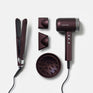The Dark Burgundy Collection hair set, including The Original Iron, Airshot Pro hair dryer, magnetic attachments, and. diffuser, all laid out on a light grey background.