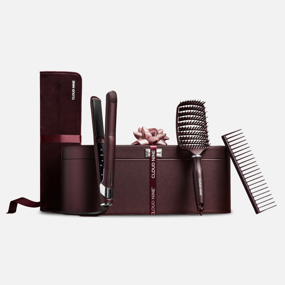 The Cloud Nine Dark Burgundy Collection hair styling tools including The Original Iron, Wet Brush, Comb, and a matching burgundy velvet styling case with 'Cloud Nine' branding, on a white background.