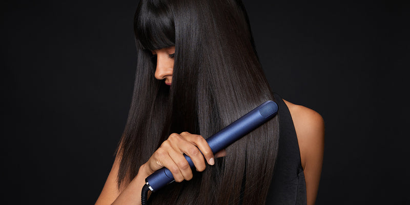 Model straightening her dark brown hair with the 2-in-1 Contouring Iron Pro.