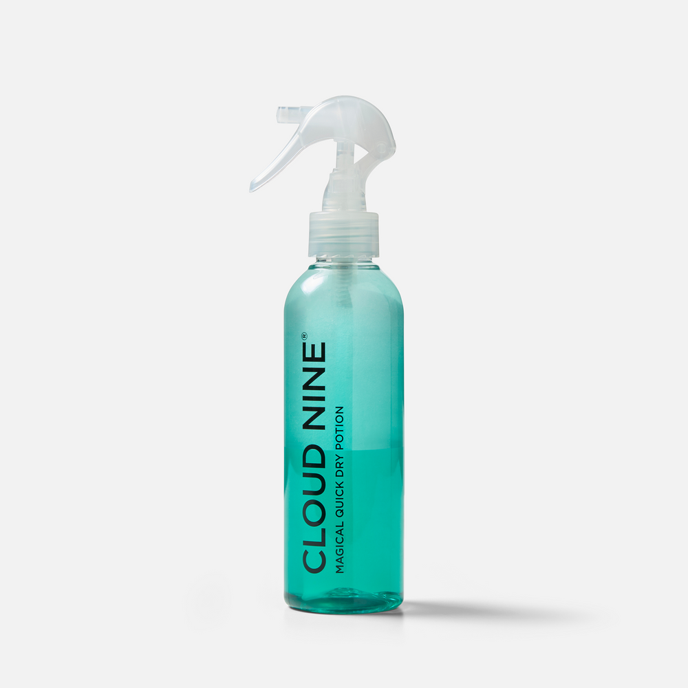 Bottle of the blue-coloured Magical Quick Dry Potion, with white nozzle and 'Cloud Nine' branding, displayed on a light grey background