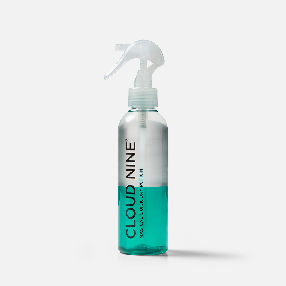 Bottle of the Magical Quick Dry Potion before it has been shaken, with a white nozzle and 'Cloud Nine' branding, displayed on a light grey background