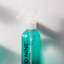 Close-up of the Magical Quick Dry Potion against a wet, shower-like surface, with a white nozzle and 'Cloud Nine' branding.