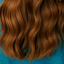Close-up of wavy red hair falling on a blue coat.