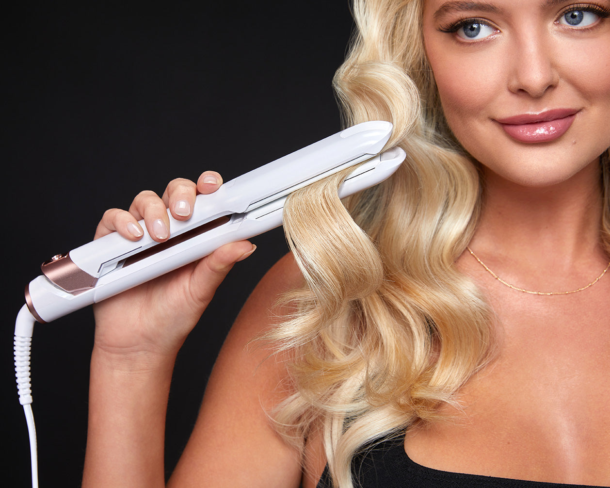 Close up of a model curling her blonde hair with the Wide Iron Pro.