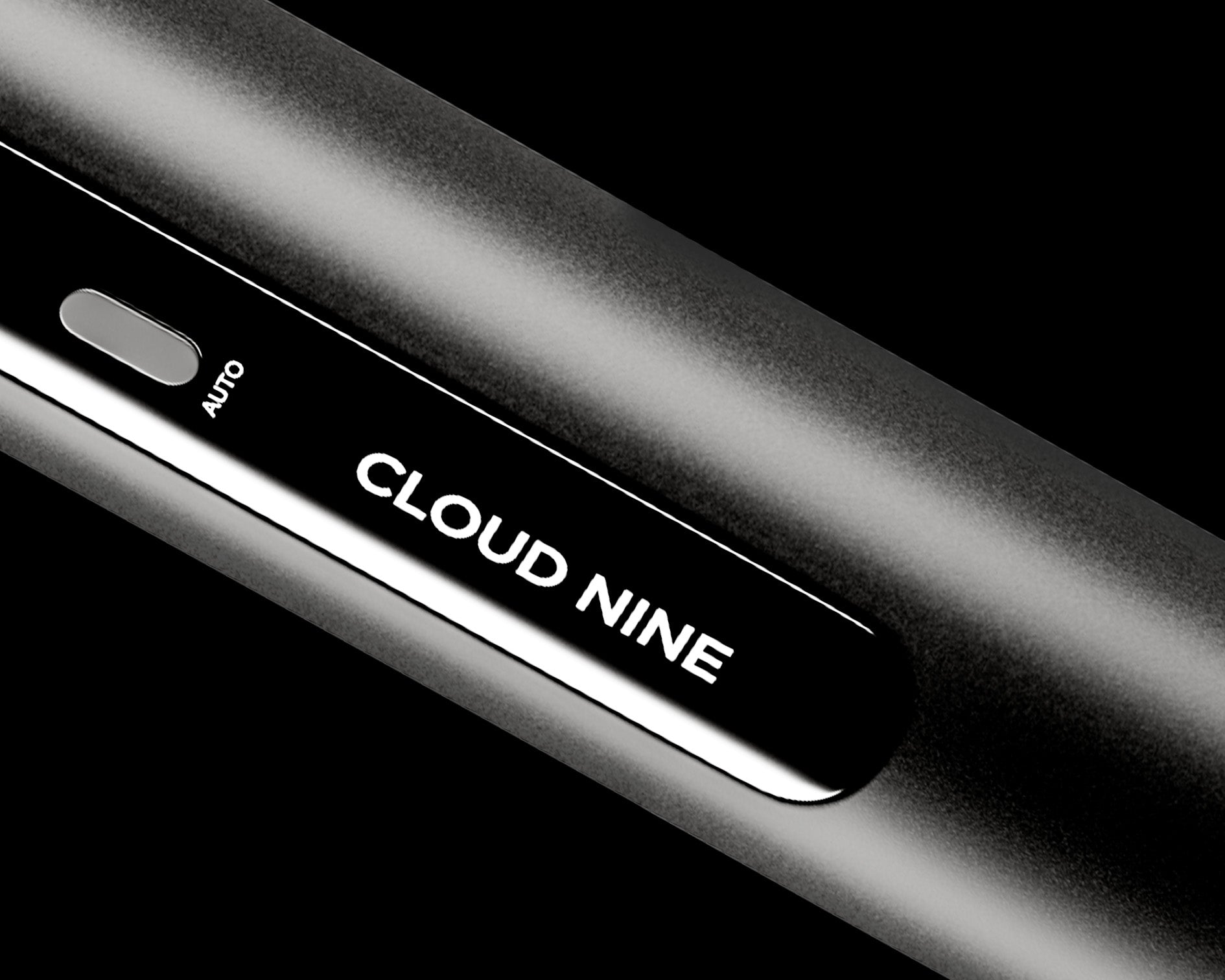 Zoomed in image of the CLOUD NINE logo in white writing on the black Curling Wand.